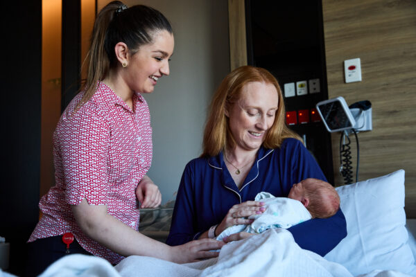 Cabrini midwife with new mum and baby