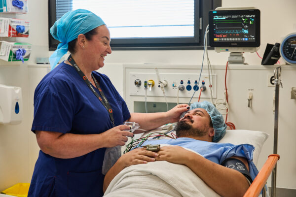 A nurse comforts a patient before their endoscopy