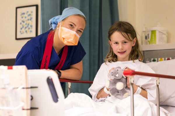 Female nurse with young girl patient