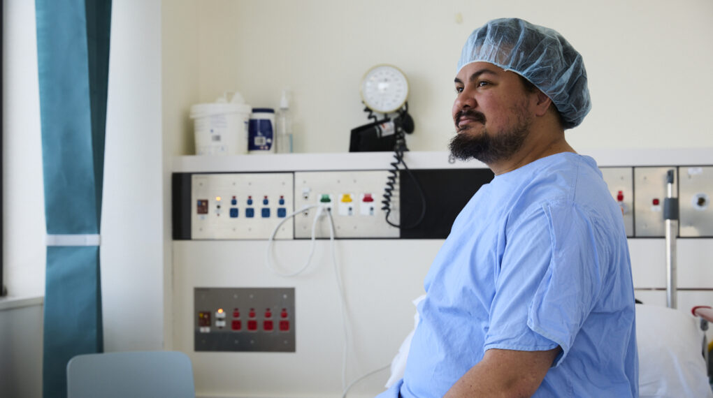 Patient sitting on bed waiting for surgery