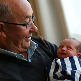 Grandparent holding their grandchild