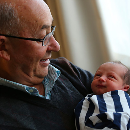 Grandparent holding their grandchild