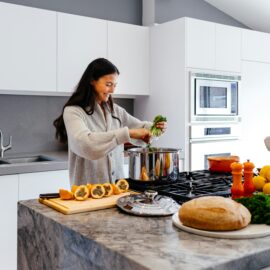 Lady preparing dinner at the kitchen bench